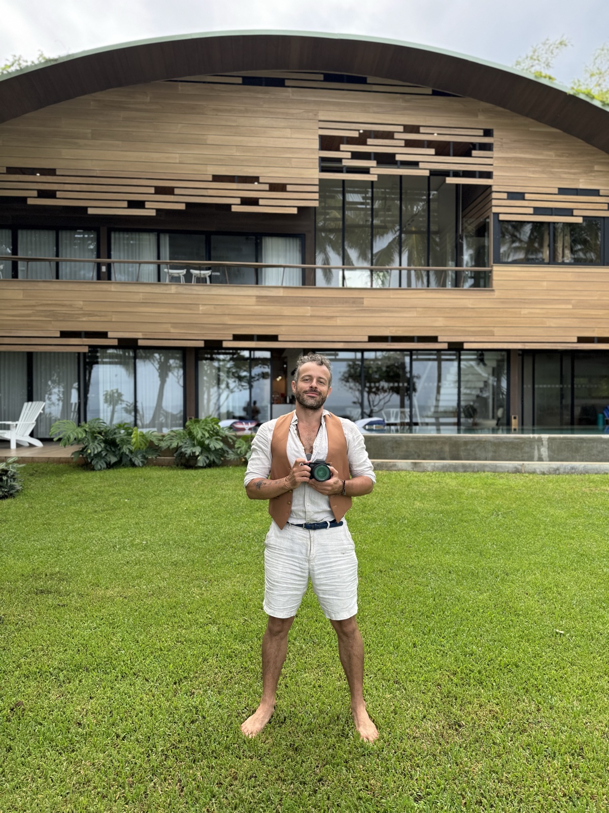 Kris Piatkowski in front of the villa, camera in hand