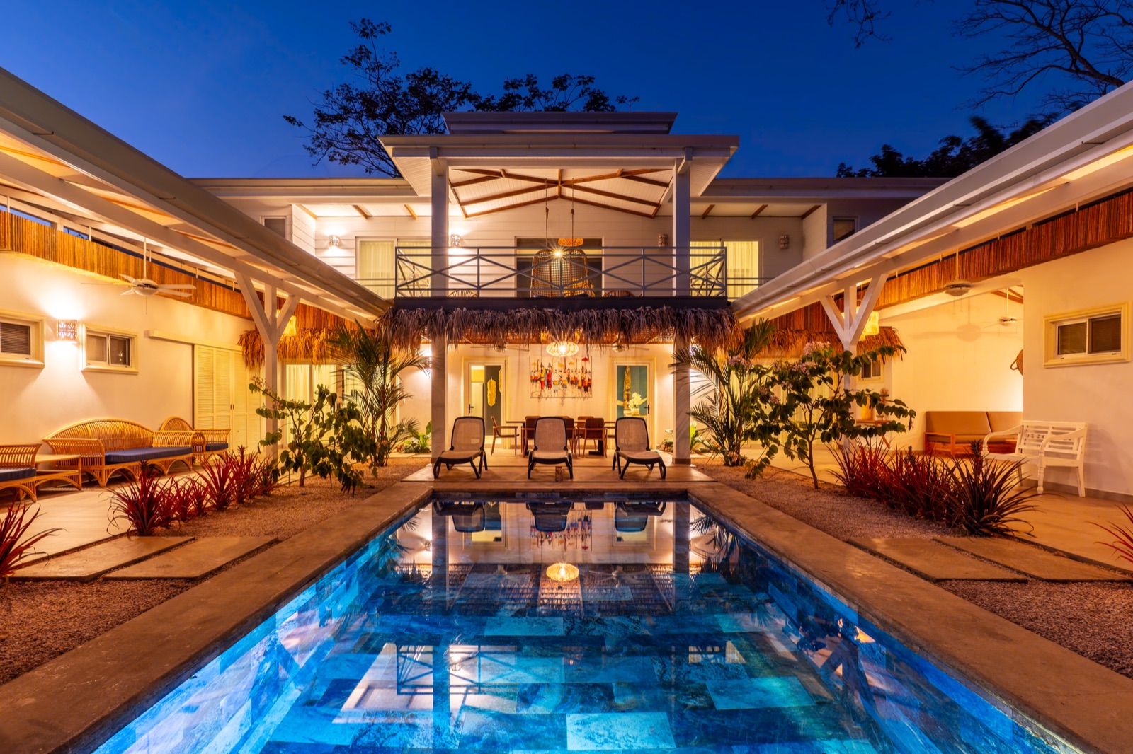 Luxury villa with illuminated pool at twilight