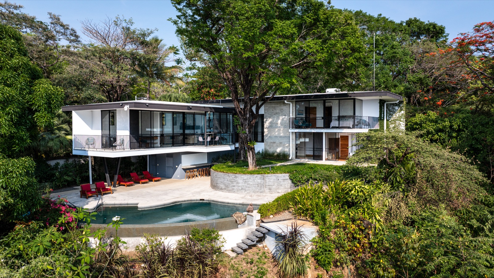 Aerial drone view of modern villa with pool