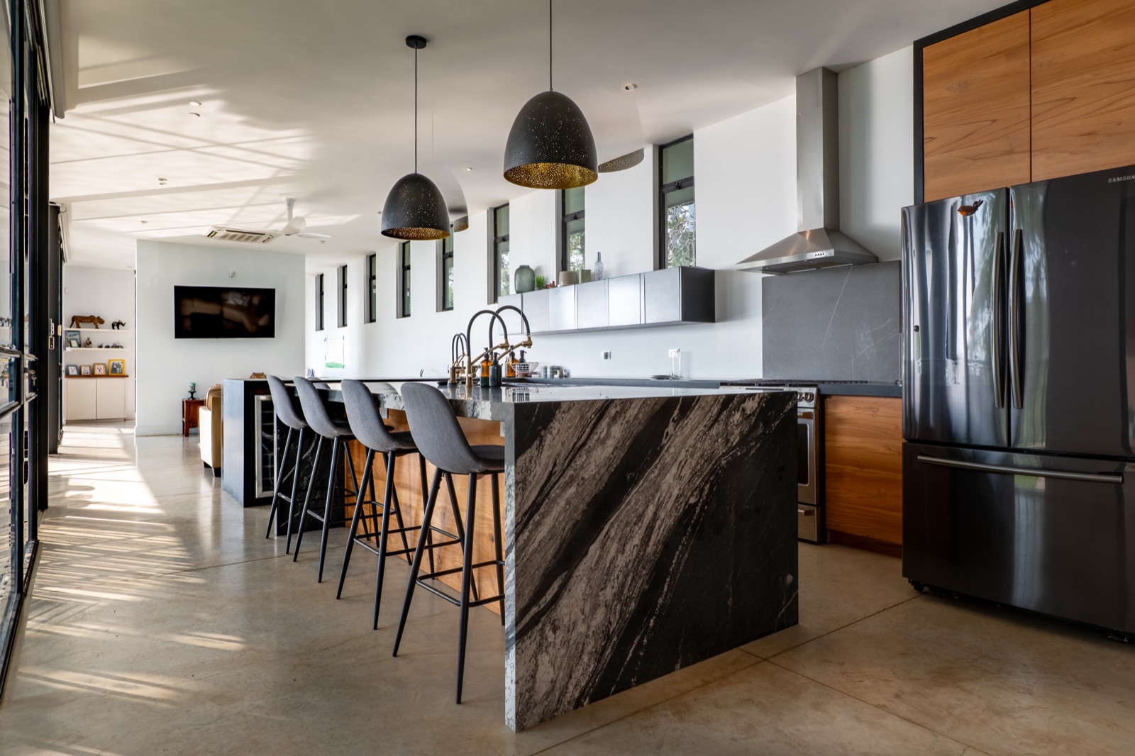 Modern kitchen with marble island and pendant lights