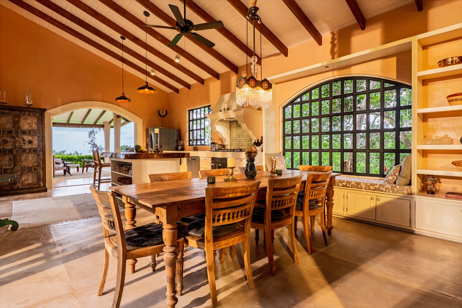 Rustic dining room with arched windows and wooden table